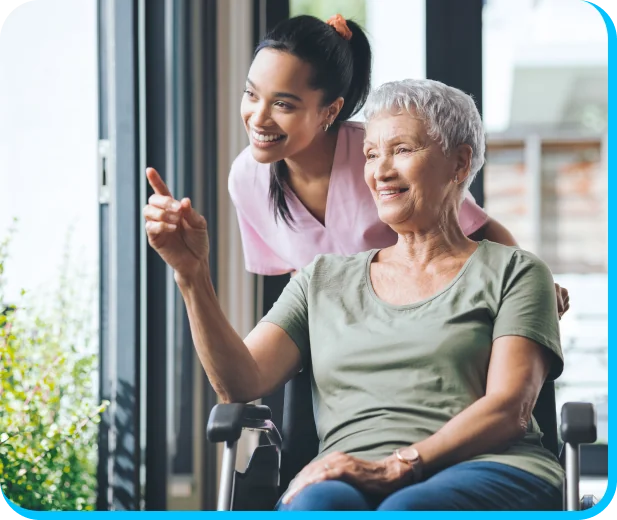 caregiver and older lady looking outside through a window