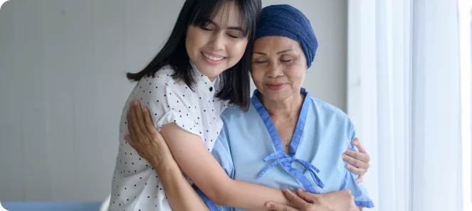 caregiver and senior lady hugging